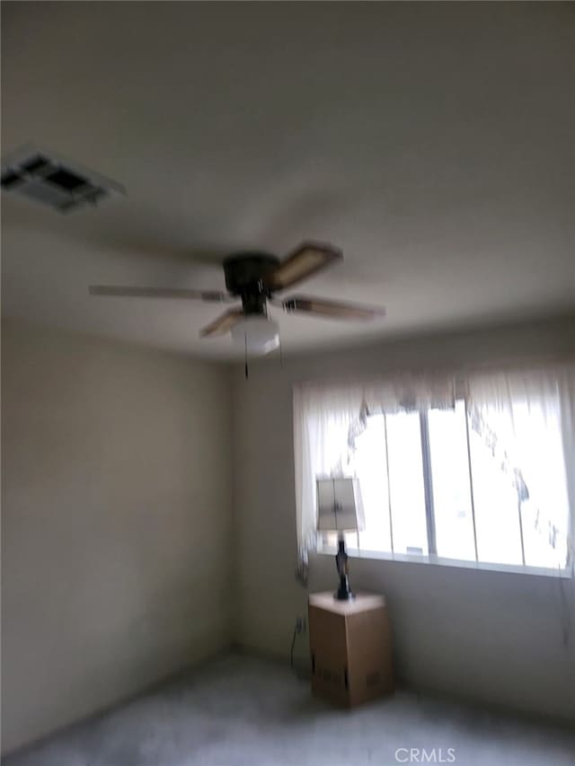 spare room featuring visible vents and ceiling fan