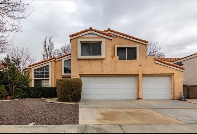 view of front of property with concrete driveway, a tiled roof, and stucco siding