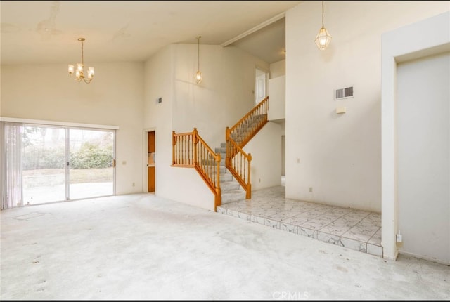 unfurnished living room featuring visible vents, high vaulted ceiling, a chandelier, and stairway