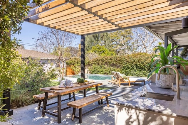 view of patio / terrace with an outdoor pool, a pergola, fence, and a sink