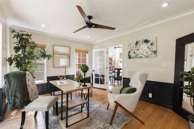 sitting room with recessed lighting, wainscoting, light wood-style floors, and ornamental molding