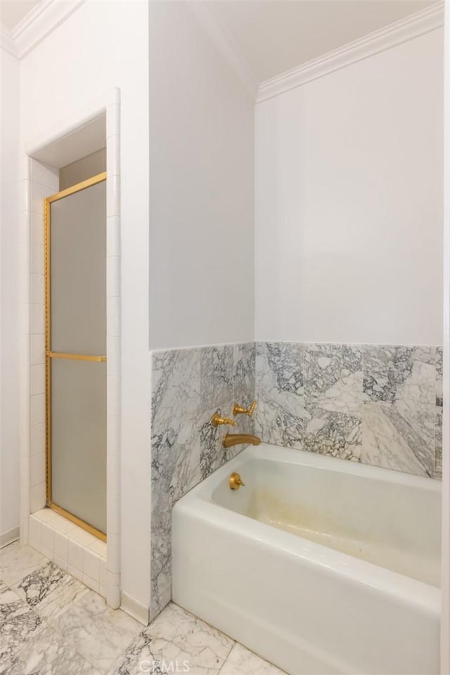 bathroom with a garden tub, marble finish floor, a stall shower, and crown molding