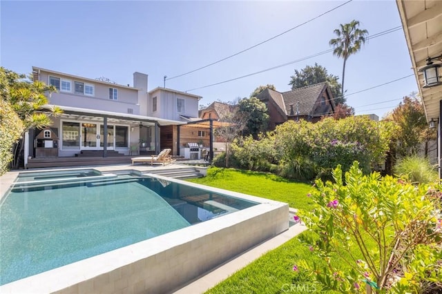 outdoor pool featuring a lawn and a wooden deck