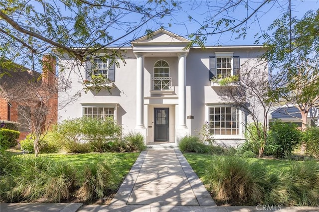 greek revival house with stucco siding