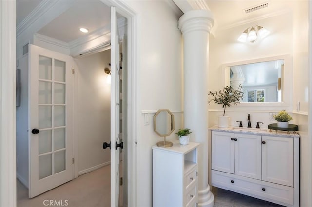 bathroom featuring visible vents, ornamental molding, vanity, and ornate columns