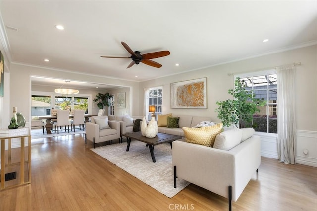 living room with recessed lighting, light wood-style floors, and ornamental molding