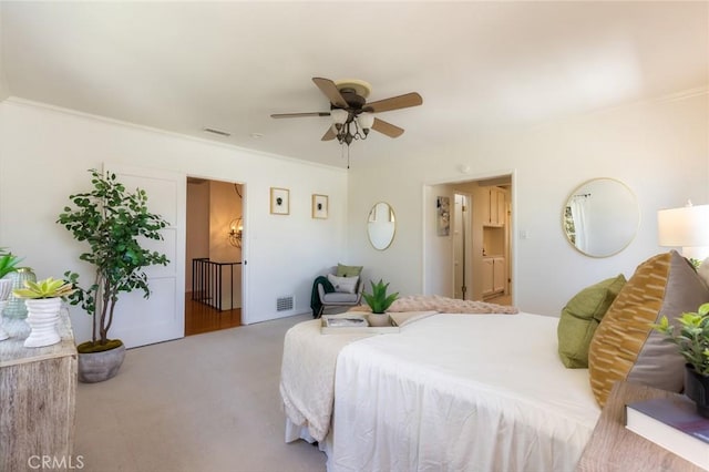 bedroom featuring visible vents, crown molding, and carpet