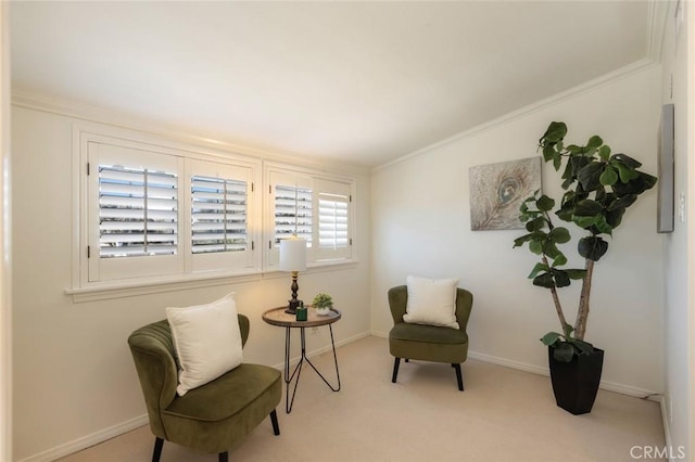 living area with baseboards, crown molding, and carpet