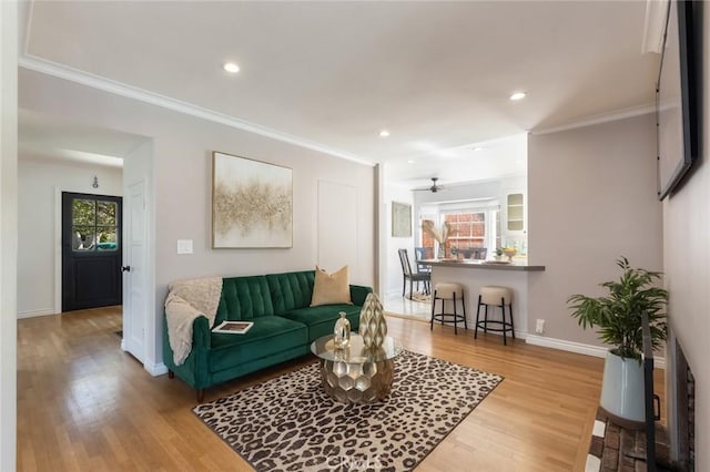 living room with recessed lighting, baseboards, wood finished floors, and ornamental molding