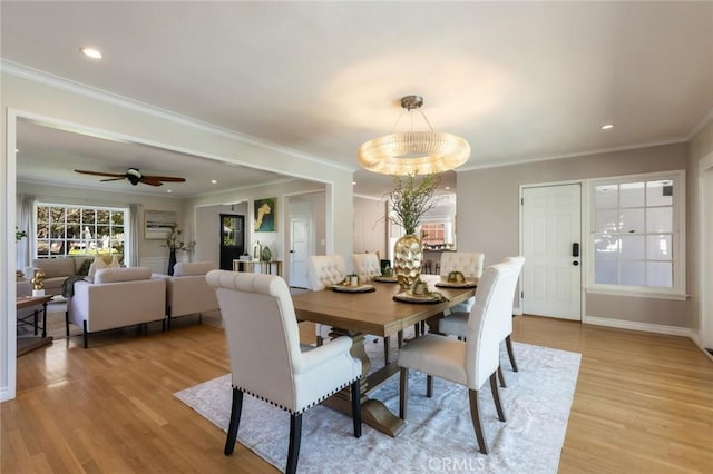 dining area featuring light wood-style flooring, recessed lighting, baseboards, and ornamental molding