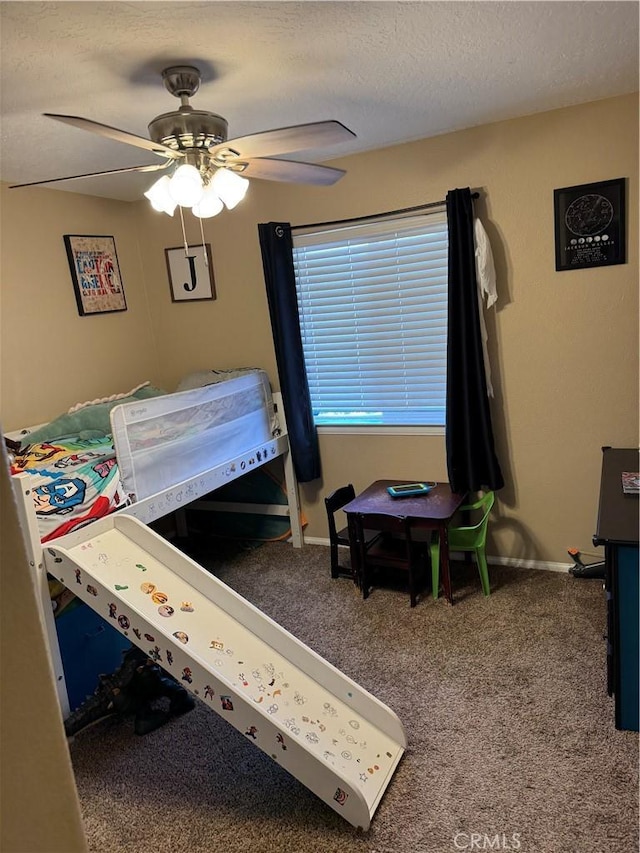 bedroom featuring carpet flooring, a ceiling fan, baseboards, and a textured ceiling