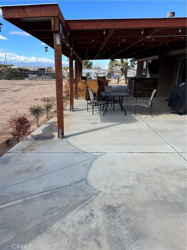 view of patio / terrace featuring area for grilling and fence