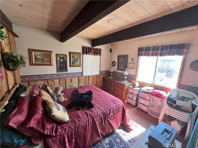 bedroom featuring wooden walls, a wainscoted wall, wood ceiling, carpet floors, and beam ceiling