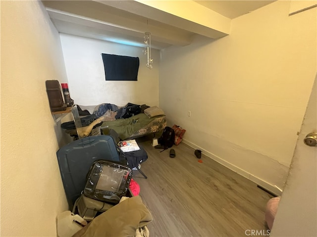 interior space featuring baseboards and wood finished floors