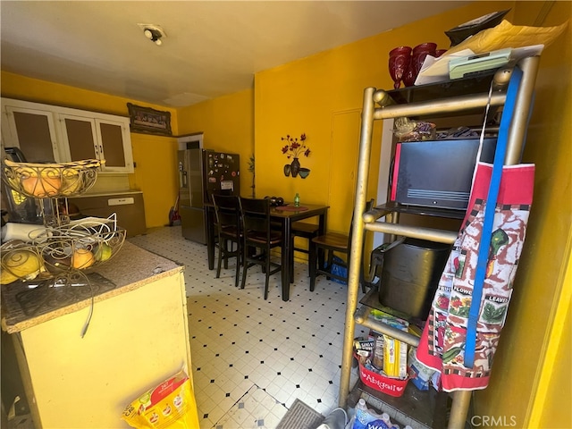 kitchen featuring stainless steel fridge and light floors