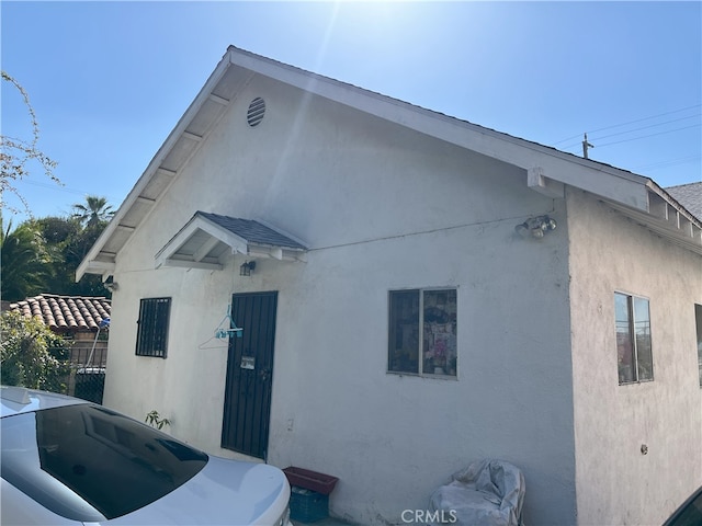 rear view of property with stucco siding