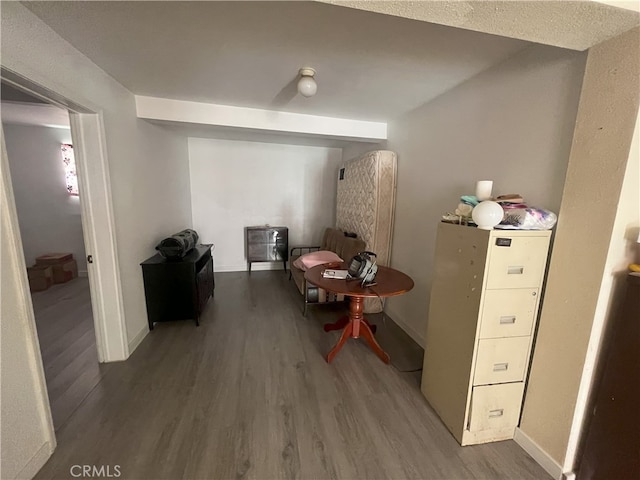 hall with baseboards and wood finished floors