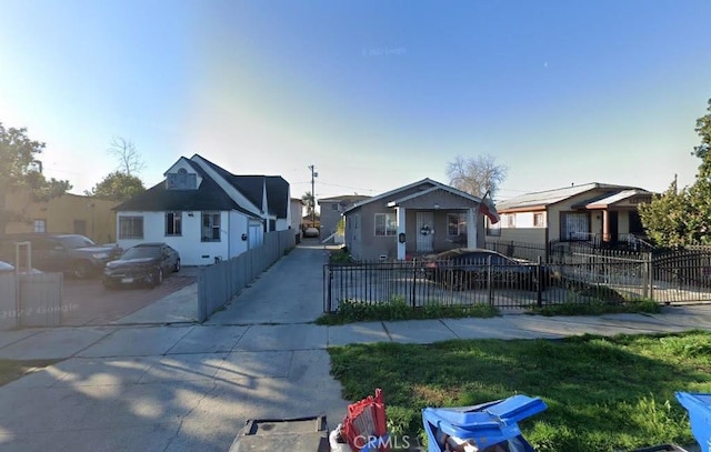 bungalow featuring a residential view and a fenced front yard