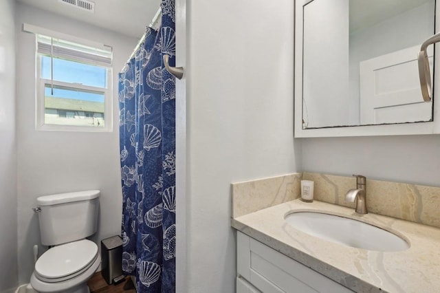 bathroom with vanity, a shower with shower curtain, toilet, and visible vents