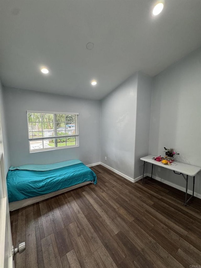 bedroom with recessed lighting, baseboards, and wood finished floors