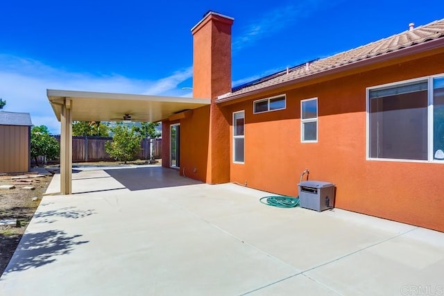 view of patio featuring an outdoor structure and fence