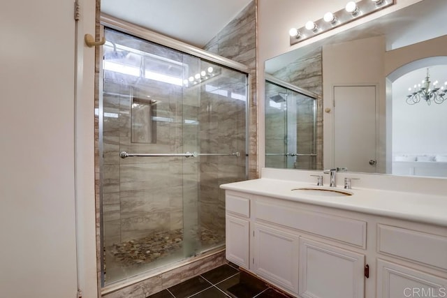 full bath featuring vanity, tile patterned floors, and a stall shower