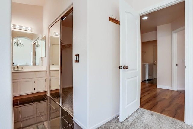 full bathroom with vanity, wood finished floors, baseboards, recessed lighting, and a walk in closet