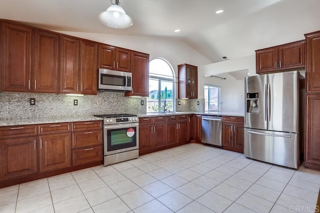 kitchen with backsplash, stainless steel appliances, light tile patterned floors, light stone countertops, and vaulted ceiling