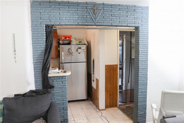 kitchen featuring tile patterned floors and freestanding refrigerator