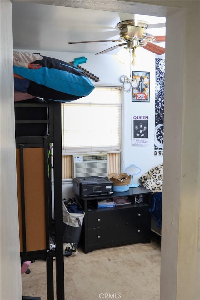 carpeted bedroom featuring cooling unit and a ceiling fan