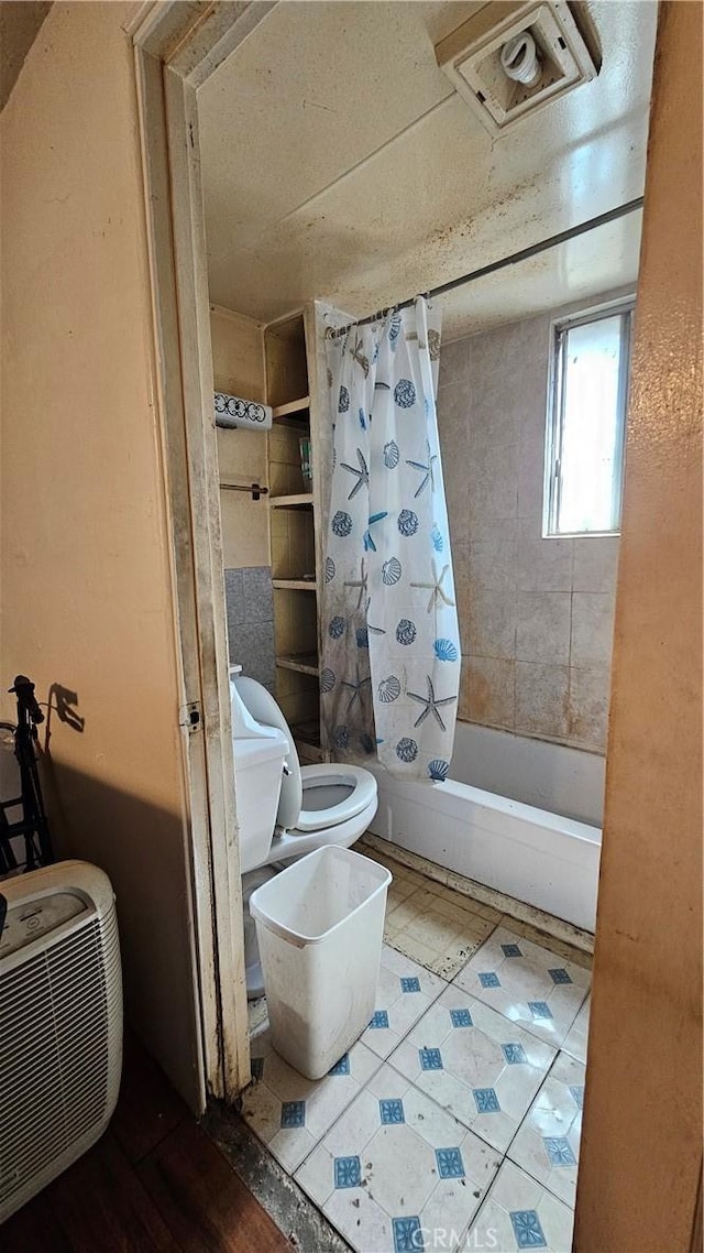 full bathroom with visible vents, shower / bath combo with shower curtain, and toilet