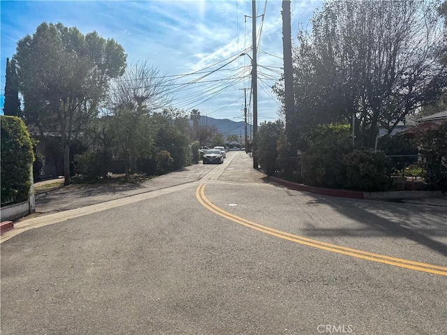 view of road featuring curbs