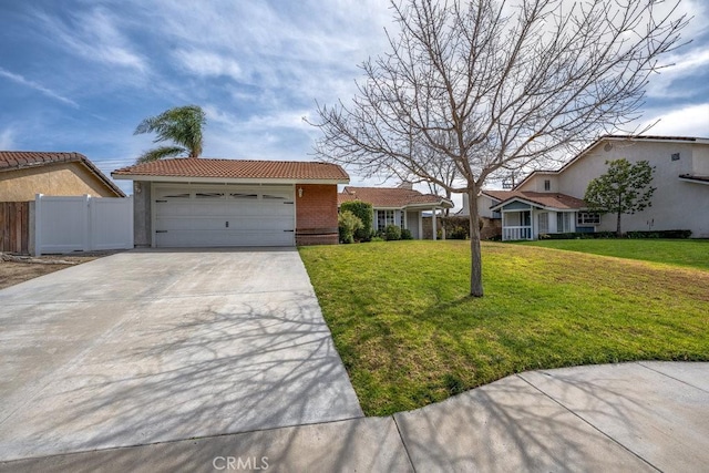 view of front of home featuring fence, concrete driveway, a front yard, a garage, and brick siding