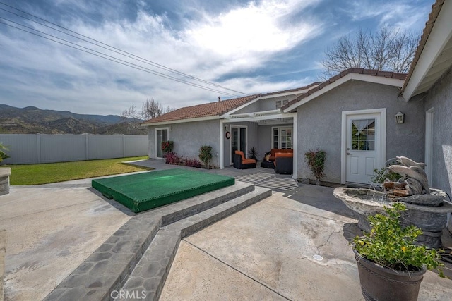 view of patio / terrace featuring a mountain view and fence