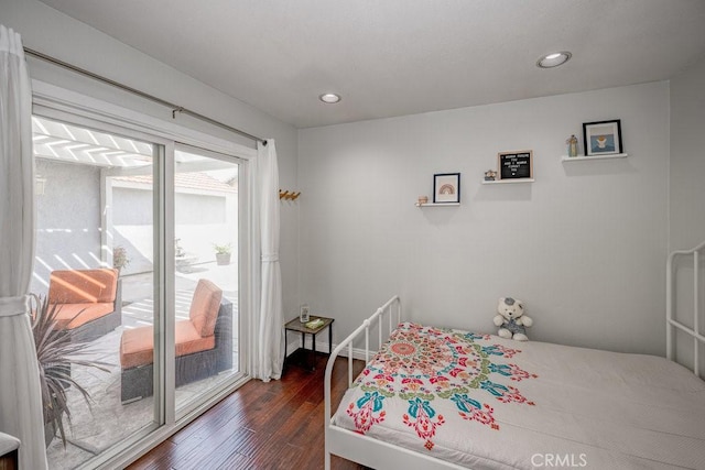 bedroom with recessed lighting, dark wood-type flooring, and access to outside