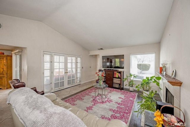 living area with visible vents, french doors, and tile patterned flooring