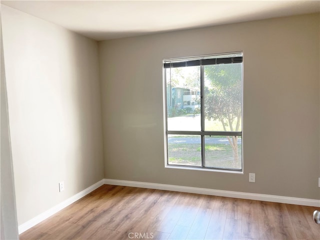 unfurnished room featuring wood finished floors and baseboards