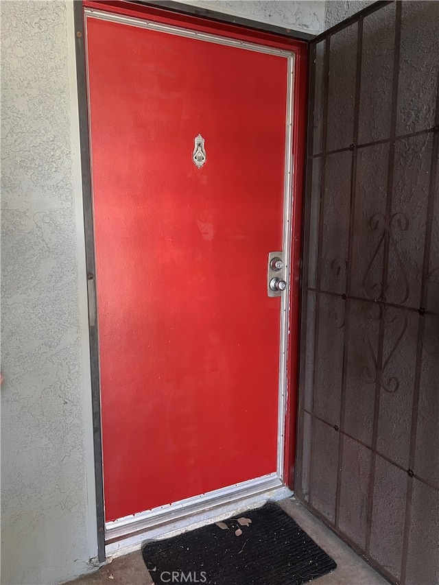 doorway to property featuring stucco siding