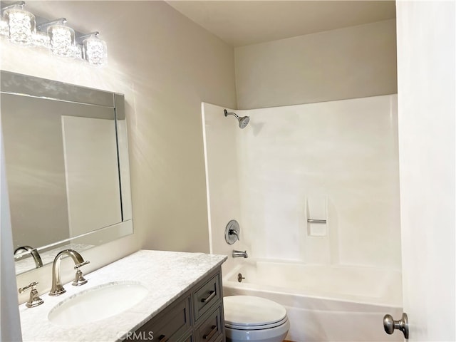 bathroom featuring vanity, toilet, and bathtub / shower combination