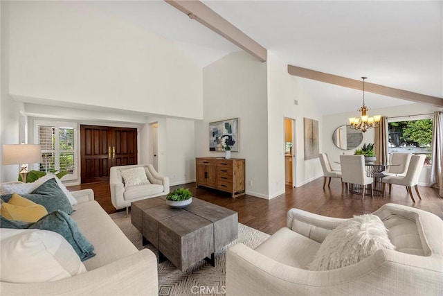 living area with a wealth of natural light, beamed ceiling, an inviting chandelier, and wood finished floors