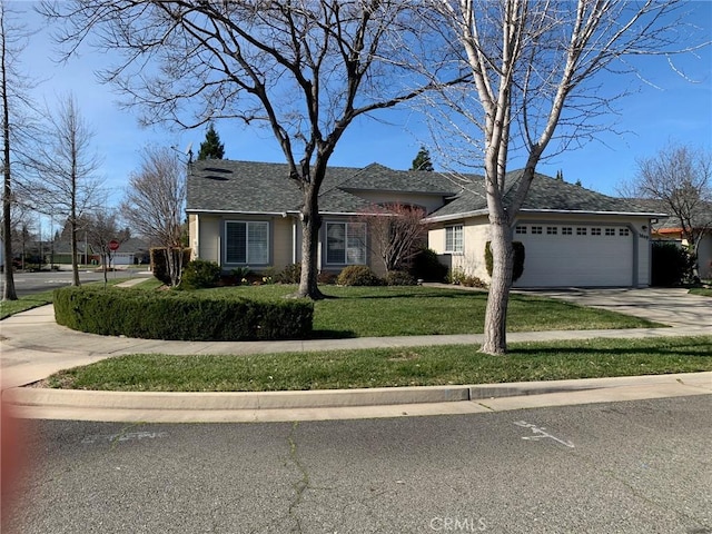 ranch-style home with a garage, driveway, and a front lawn