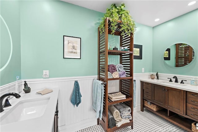 bathroom featuring recessed lighting, a wainscoted wall, and vanity