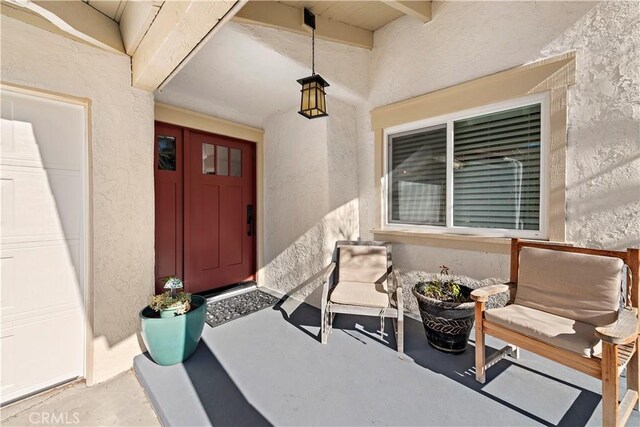 property entrance with stucco siding