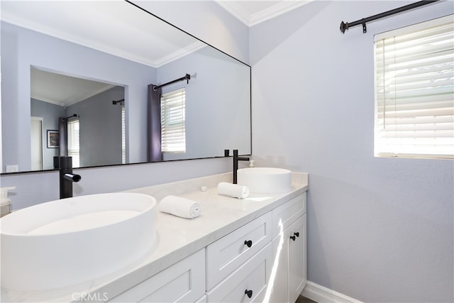 full bathroom featuring double vanity, ornamental molding, and a sink