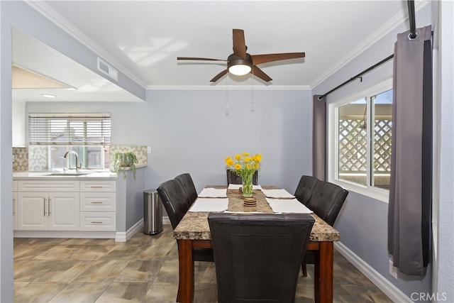 dining area with visible vents, baseboards, ceiling fan, and crown molding