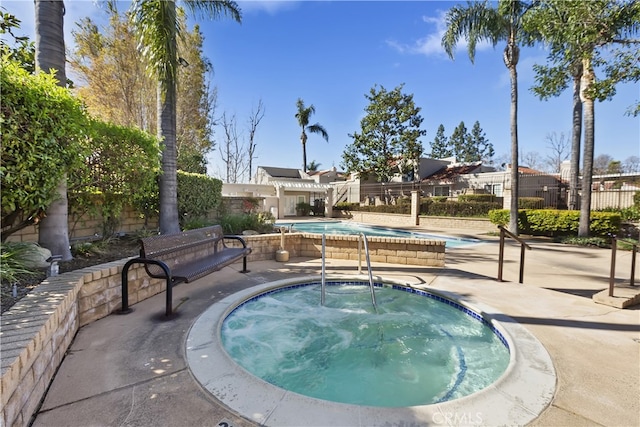 pool featuring a patio, a community hot tub, and fence