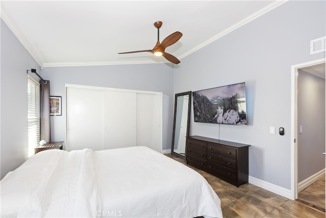 bedroom featuring a closet, visible vents, crown molding, and baseboards