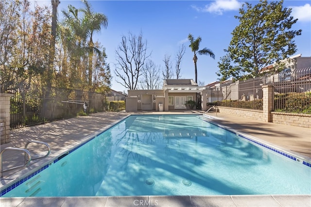 community pool featuring a patio and fence