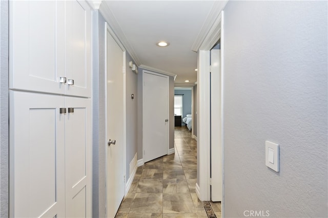 hallway featuring recessed lighting, crown molding, and baseboards