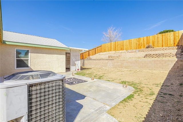 view of patio with central air condition unit and a fenced backyard